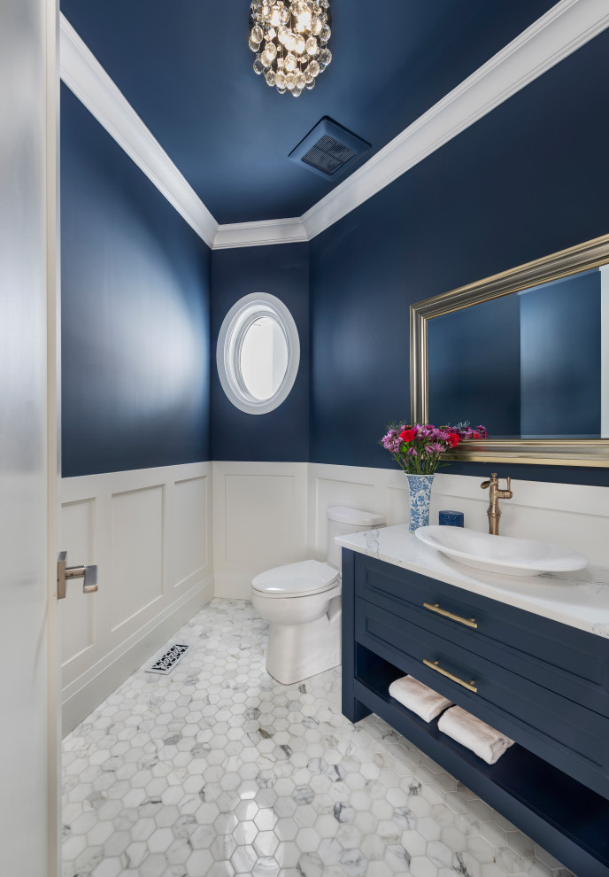Medium sized cloakroom in Ottawa with recessed-panel cabinets, blue cabinets, a one-piece toilet, blue walls, a vessel sink, engineered stone worktops, white floors, white worktops, a freestanding vanity unit and wainscoting.