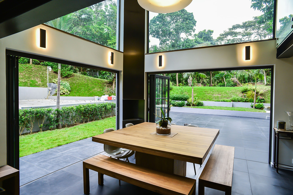 Contemporary dining room in Hong Kong with beige walls and black floor.