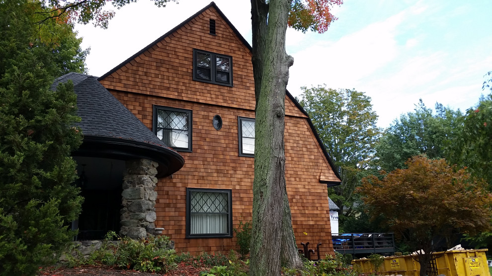Design ideas for a large traditional three-storey brown house exterior in Boston with wood siding, a hip roof, a shingle roof, a black roof and shingle siding.