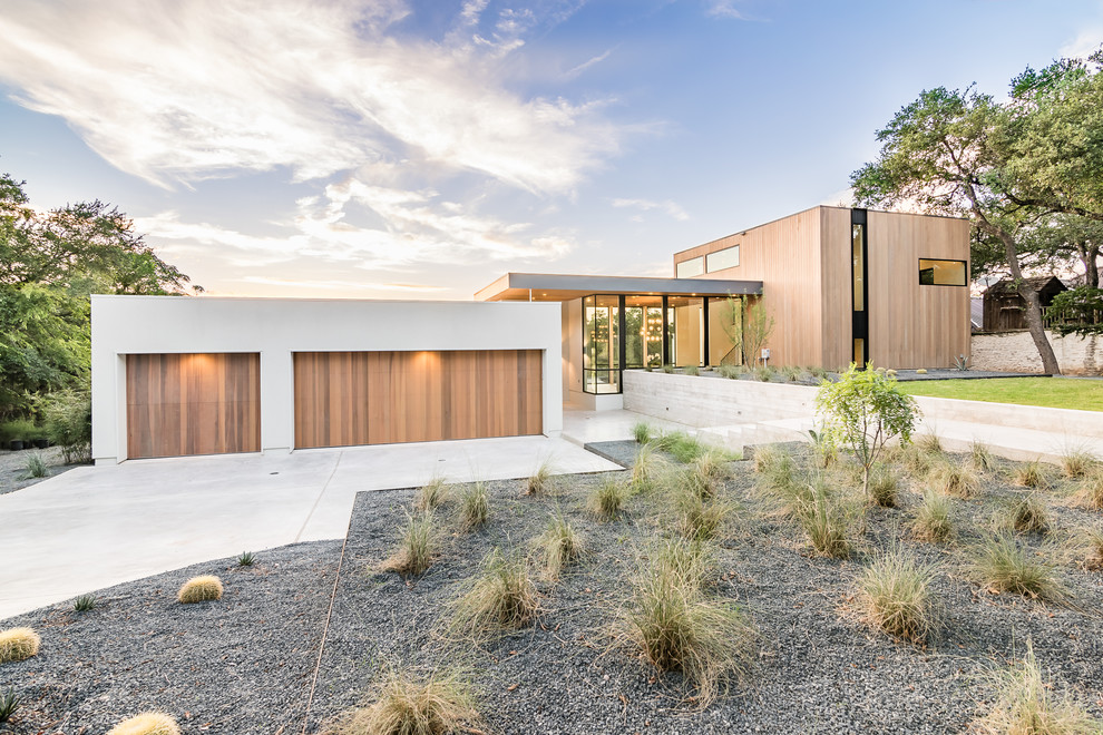 Photo of a contemporary house exterior in Austin with wood siding and a flat roof.