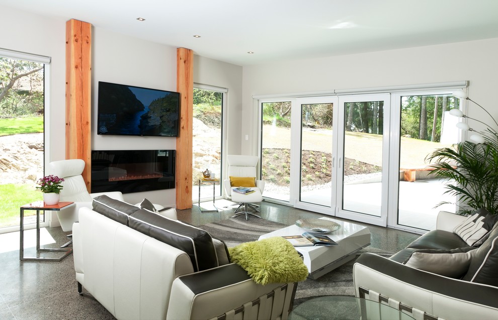 This is an example of a large contemporary formal open concept living room in Vancouver with a wall-mounted tv, grey walls, concrete floors and a ribbon fireplace.