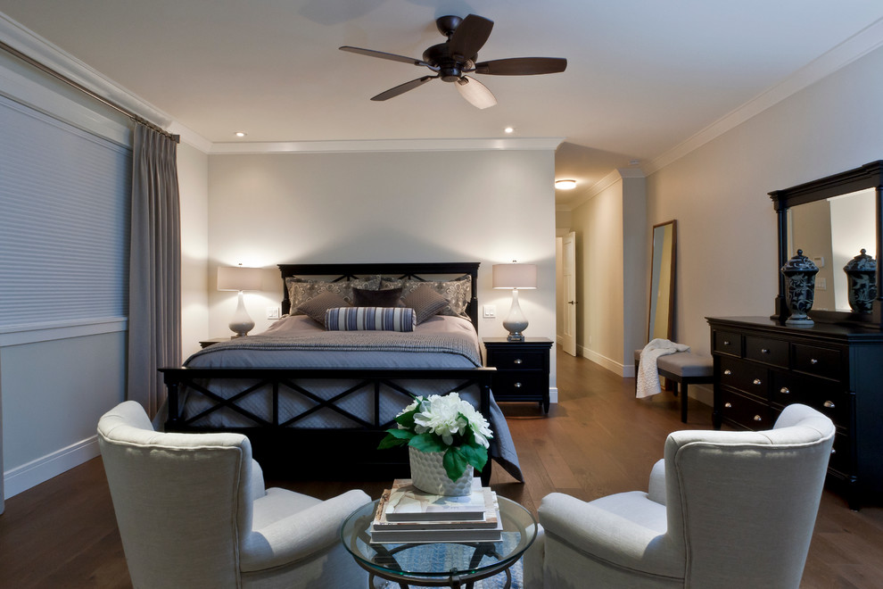 This is an example of a mid-sized beach style master bedroom in Vancouver with grey walls and medium hardwood floors.