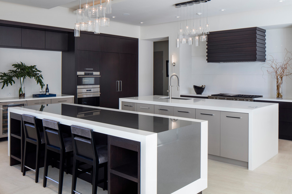 Design ideas for a large contemporary l-shaped kitchen in Orlando with flat-panel cabinets, quartz benchtops, white splashback, porcelain floors, multiple islands, an undermount sink, dark wood cabinets, stainless steel appliances and beige floor.