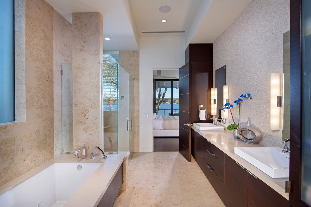 Inspiration for a large contemporary master bathroom in Orlando with flat-panel cabinets, dark wood cabinets, an undermount tub, beige tile, a corner shower, stone tile, beige walls, porcelain floors, a vessel sink, engineered quartz benchtops, brown floor and a hinged shower door.