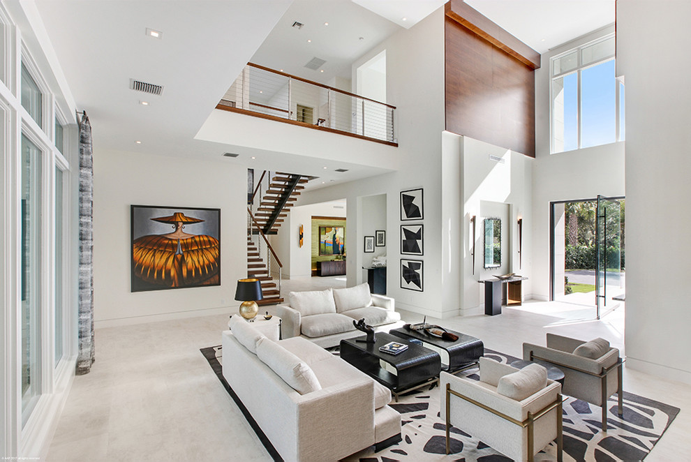 Expansive contemporary loft-style living room in Miami with beige walls, ceramic floors, a ribbon fireplace, a wood fireplace surround and beige floor.
