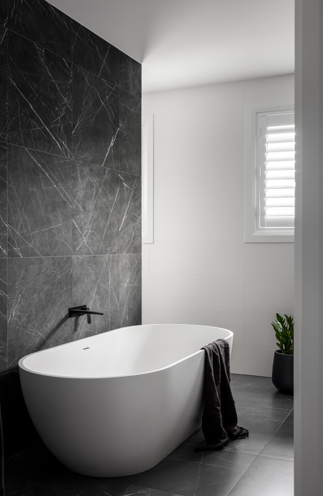 This is an example of a large contemporary bathroom in Sydney with a freestanding tub, an alcove shower, gray tile, porcelain tile, grey walls, porcelain floors, grey floor, an open shower and a floating vanity.