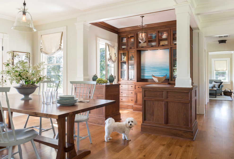 Photo of a beach style dining room in Providence with beige walls and medium hardwood floors.