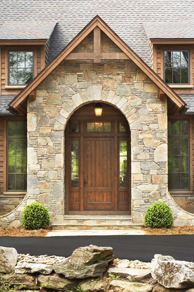 Photo of a country front door in Other with a single front door and a dark wood front door.