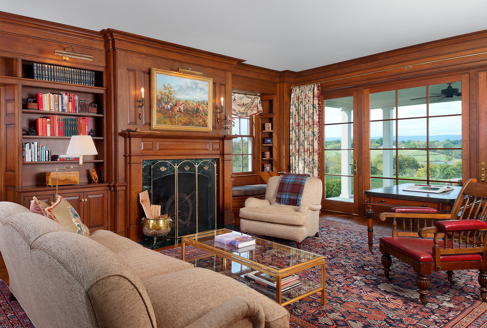 Photo of a traditional living room in DC Metro with a library, dark hardwood floors, a standard fireplace and no tv.