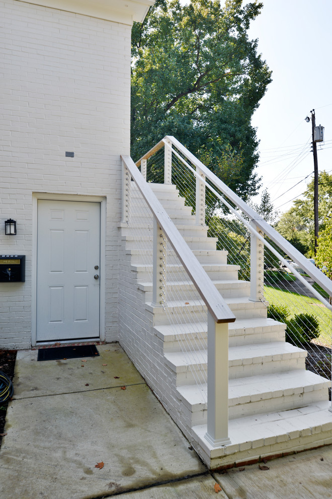 This is an example of an expansive modern two-storey white house exterior in DC Metro with mixed siding.