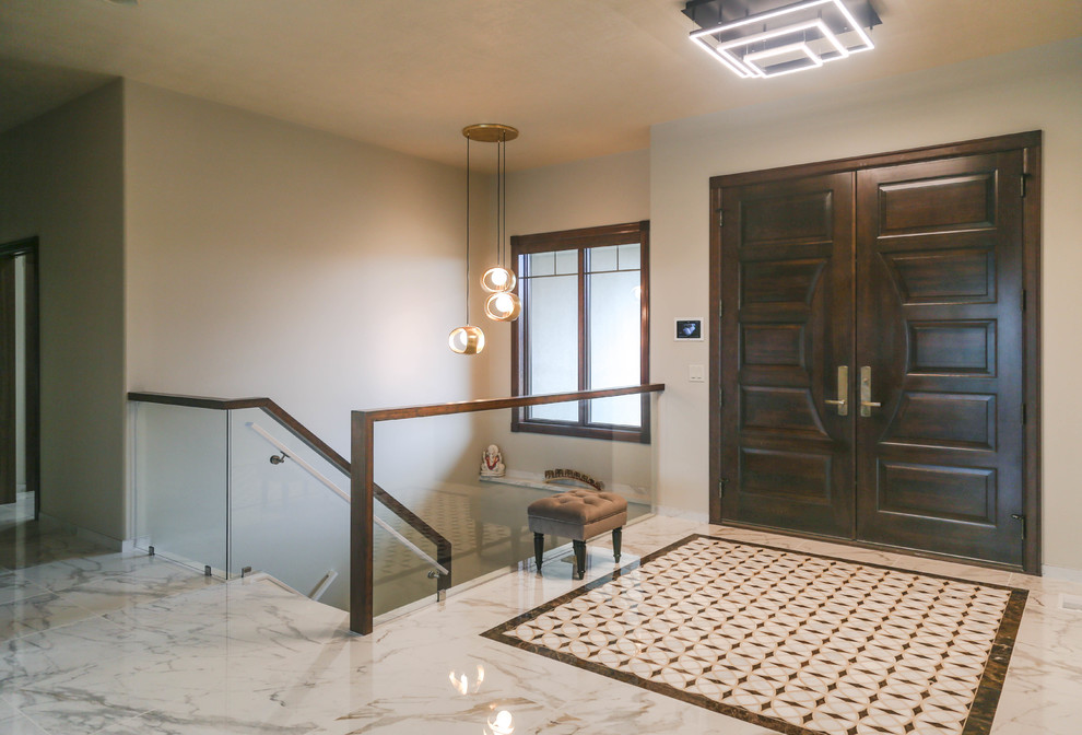 Mid-sized trendy porcelain tile and white floor foyer photo with white walls and a medium wood front door
