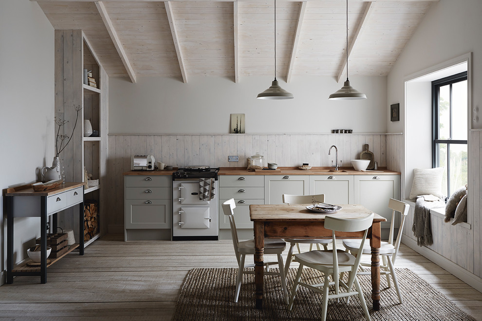 Design ideas for a mid-sized traditional single-wall eat-in kitchen in Other with an integrated sink, shaker cabinets, grey cabinets, wood benchtops, white splashback, panelled appliances, painted wood floors and white floor.