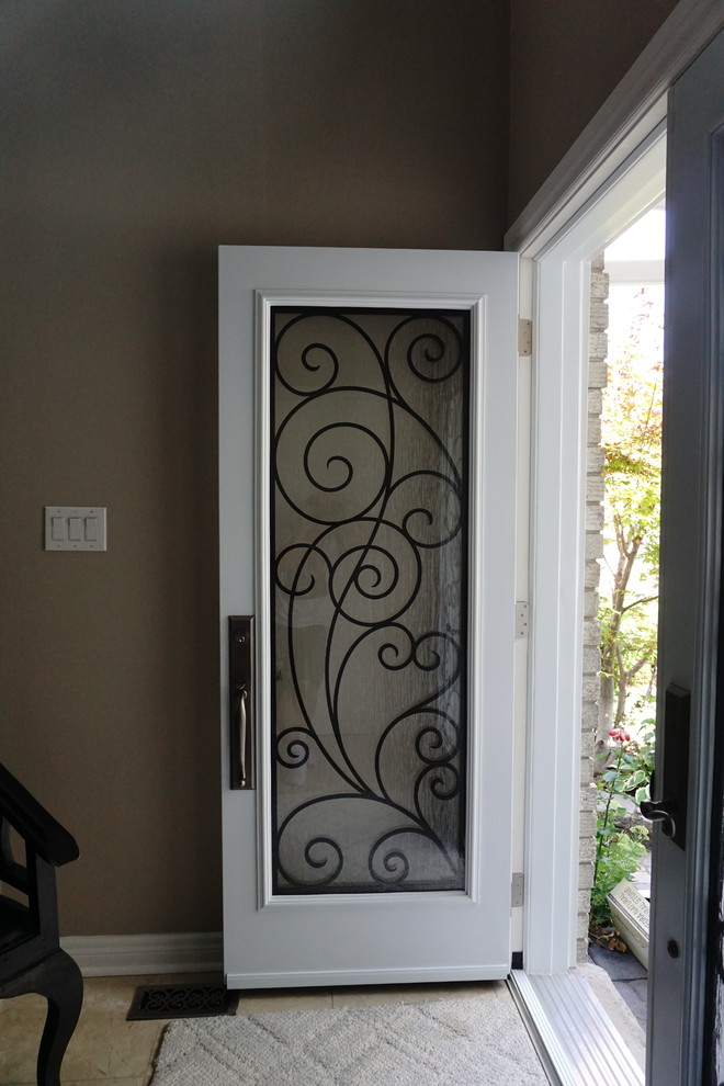 Inspiration for a mid-sized transitional ceramic tile entry hall remodel in Toronto with brown walls and a white front door