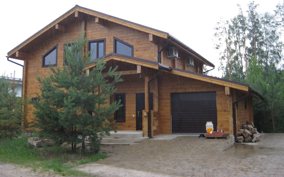 Inspiration for a contemporary two-storey exterior in Moscow with wood siding.