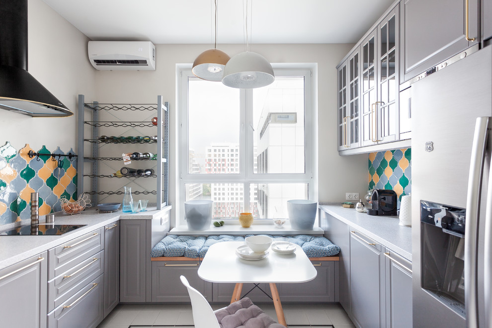 Small transitional galley eat-in kitchen in Moscow with solid surface benchtops, multi-coloured splashback, ceramic splashback, ceramic floors, no island, beige floor, white benchtop, raised-panel cabinets and grey cabinets.