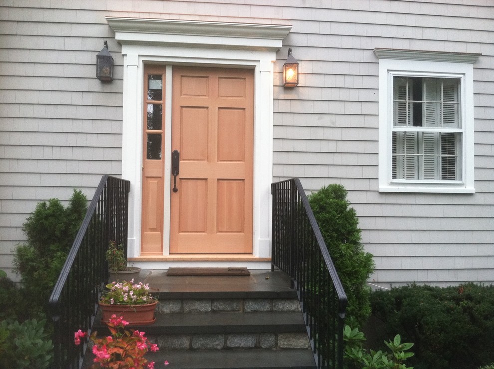 Mid-sized beach style front door in New York with a single front door and a light wood front door.