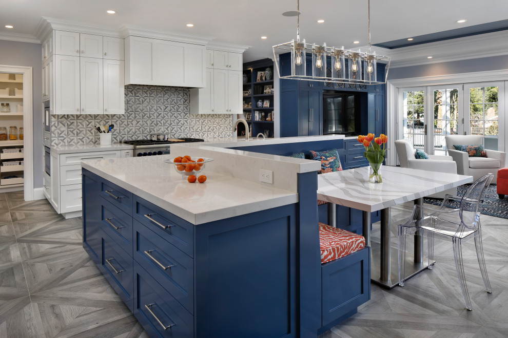 Design ideas for a large country l-shaped kitchen in San Francisco with a farmhouse sink, shaker cabinets, white cabinets, quartz benchtops, multi-coloured splashback, stainless steel appliances, porcelain floors, with island, grey floor and white benchtop.