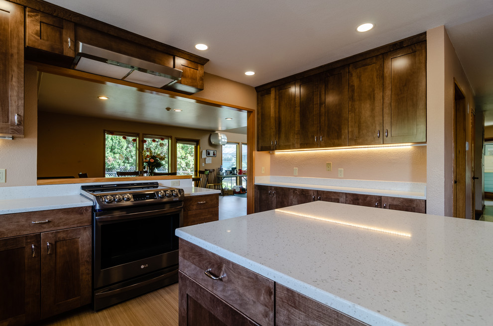 Enclosed kitchen - large transitional u-shaped light wood floor and beige floor enclosed kitchen idea with an undermount sink, recessed-panel cabinets, dark wood cabinets, quartz countertops, stainless steel appliances, an island and white countertops