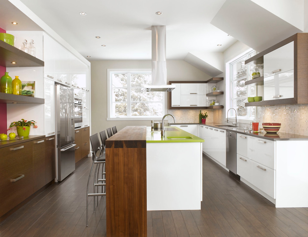 Design ideas for a contemporary galley kitchen in Montreal with an undermount sink, flat-panel cabinets, dark wood cabinets, stainless steel appliances, dark hardwood floors, quartzite benchtops and a peninsula.