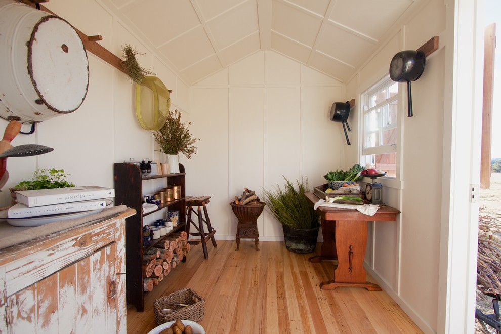 This is an example of a country studio in Wollongong with light hardwood floors.