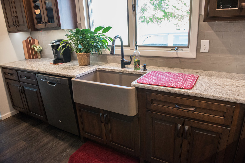 Inspiration for a huge transitional l-shaped medium tone wood floor open concept kitchen remodel with a farmhouse sink, raised-panel cabinets, medium tone wood cabinets, quartz countertops, gray backsplash, subway tile backsplash, stainless steel appliances, an island and multicolored countertops