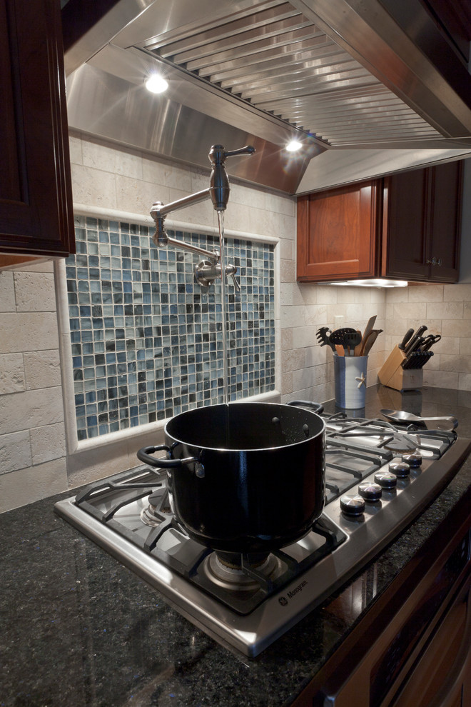 Example of a mid-sized transitional l-shaped light wood floor eat-in kitchen design in Bridgeport with an undermount sink, recessed-panel cabinets, medium tone wood cabinets, granite countertops, white backsplash, stone tile backsplash, stainless steel appliances and a peninsula