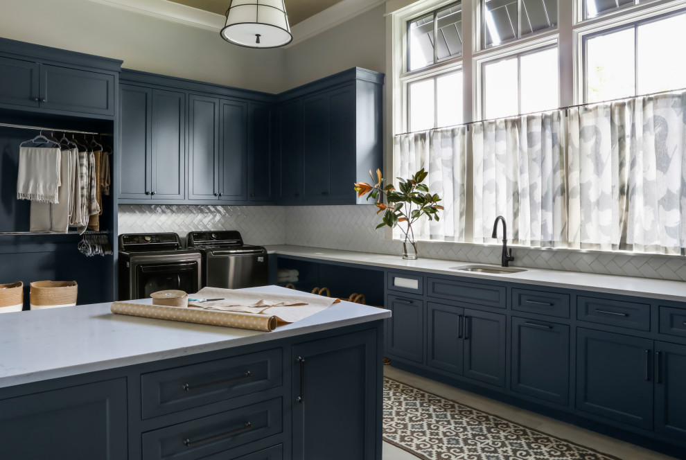 Design ideas for a large country u-shaped utility room in Nashville with an undermount sink, shaker cabinets, blue cabinets, quartz benchtops, white splashback, subway tile splashback, grey walls, porcelain floors, a side-by-side washer and dryer, grey floor, grey benchtop and wallpaper.
