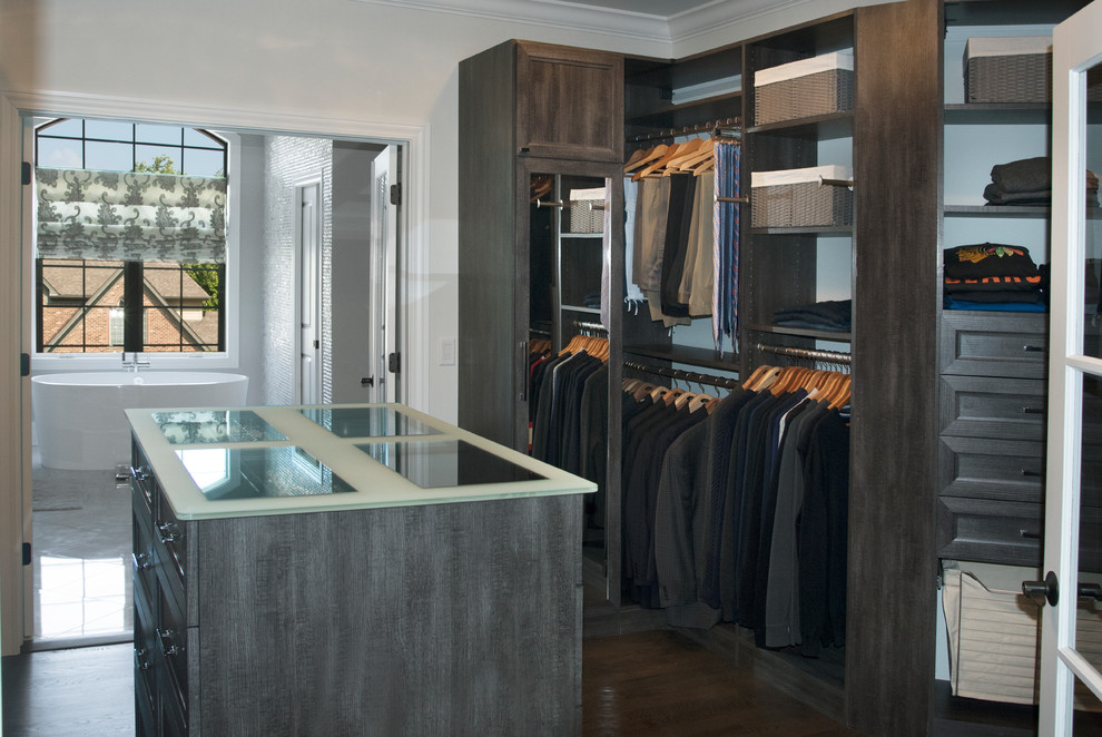 This is an example of a mid-sized transitional gender-neutral walk-in wardrobe in Chicago with recessed-panel cabinets, distressed cabinets, dark hardwood floors and brown floor.