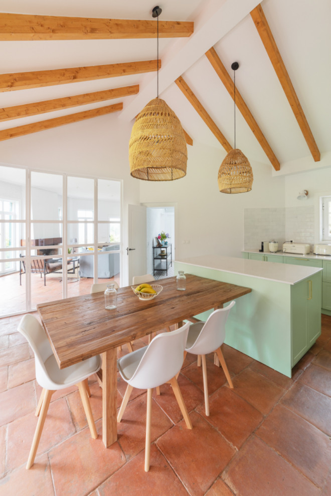 Large rustic l-shaped open plan kitchen in Other with an integrated sink, flat-panel cabinets, green cabinets, quartz worktops, grey splashback, porcelain splashback, stainless steel appliances, terracotta flooring, an island, brown floors, white worktops and exposed beams.