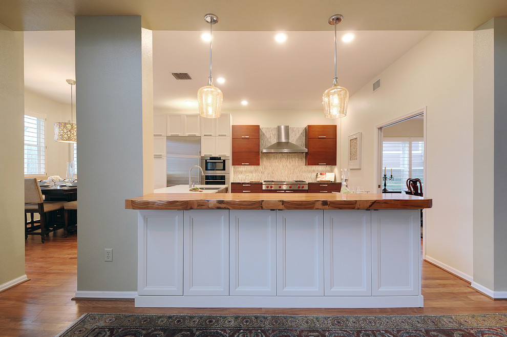 Inspiration for a large transitional l-shaped dark wood floor open concept kitchen remodel in Tampa with a farmhouse sink, gray backsplash, matchstick tile backsplash, stainless steel appliances and an island