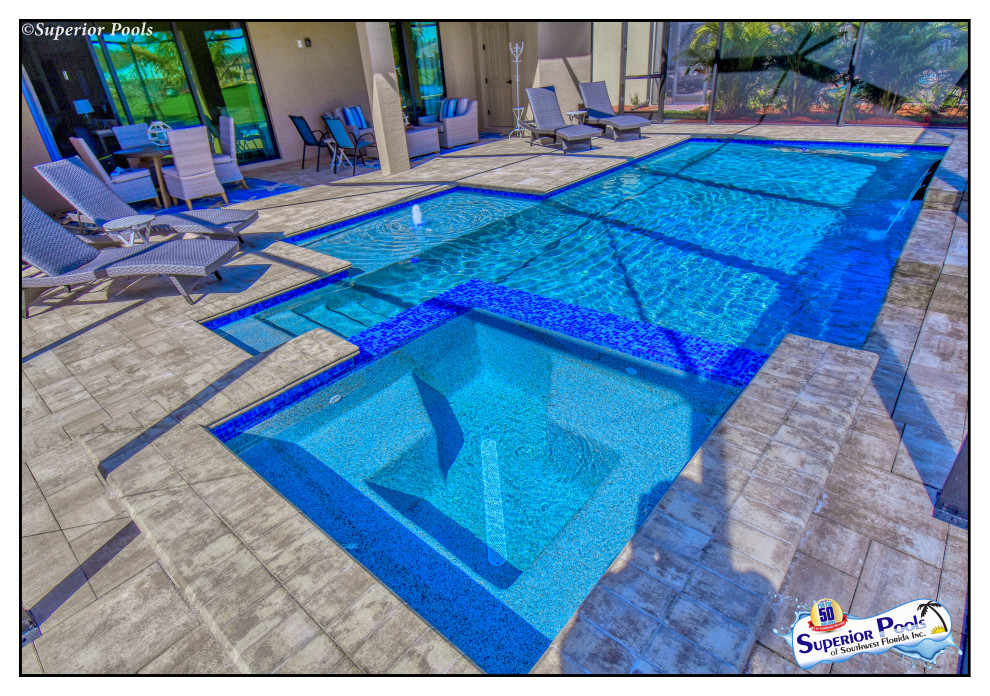 Design ideas for a mid-sized contemporary backyard rectangular lap pool in Tampa with a pool house and brick pavers.