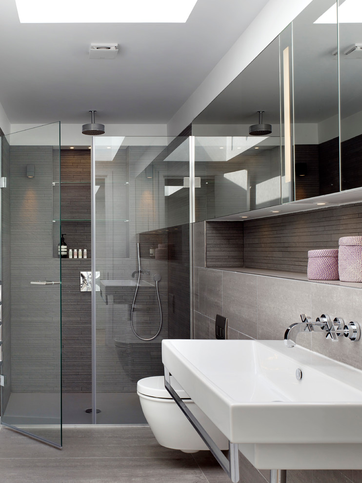 Inspiration for a contemporary bathroom in London with a wall-mount sink and brown walls.