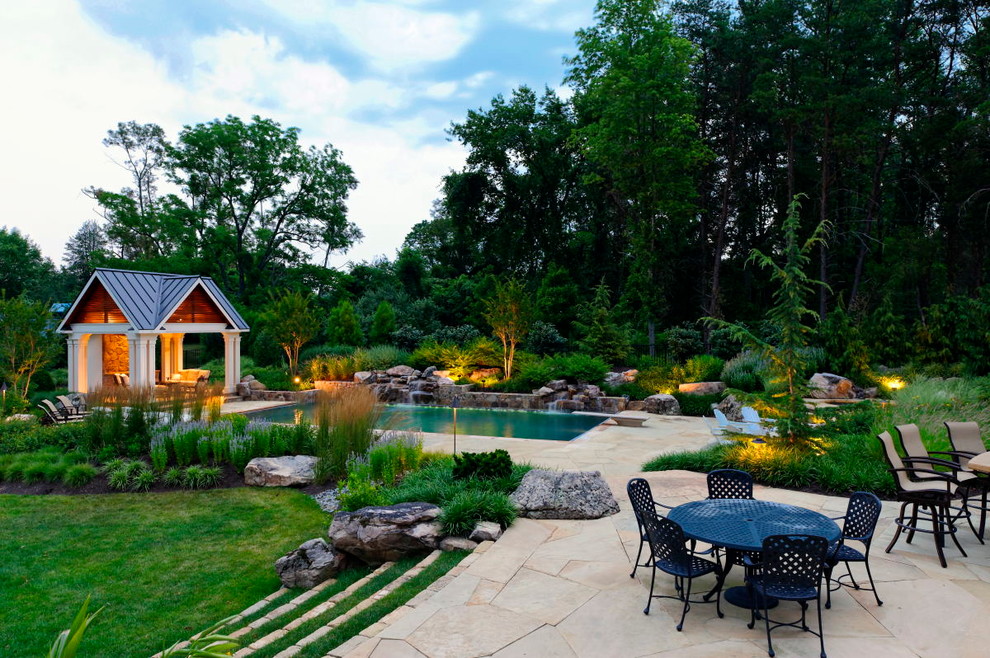Large transitional backyard garden in DC Metro with a water feature and natural stone pavers.