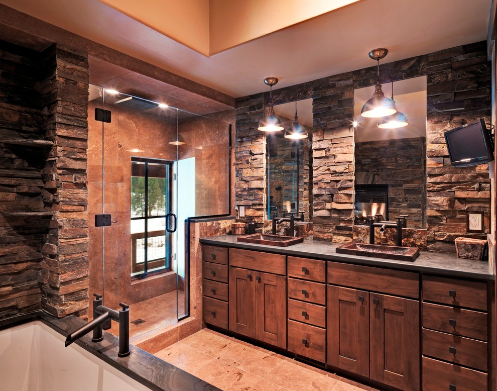 Photo of a country bathroom in Sacramento with a drop-in sink, shaker cabinets, medium wood cabinets, an alcove shower, stone tile and brown tile.