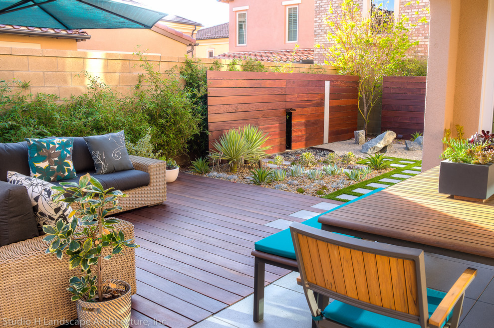 Photo of a small contemporary backyard xeriscape in Orange County with decking.