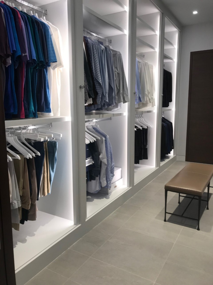 This is an example of a large modern men's walk-in wardrobe in Dallas with flat-panel cabinets, grey cabinets, ceramic floors and grey floor.