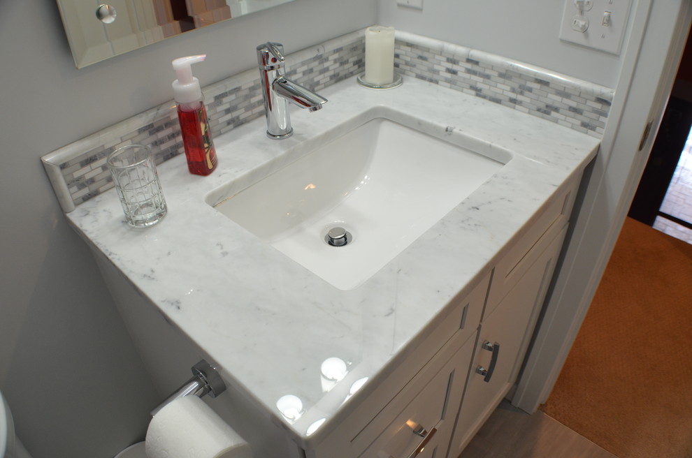 Inspiration for a transitional gray tile bathroom remodel with shaker cabinets, white cabinets and marble countertops
