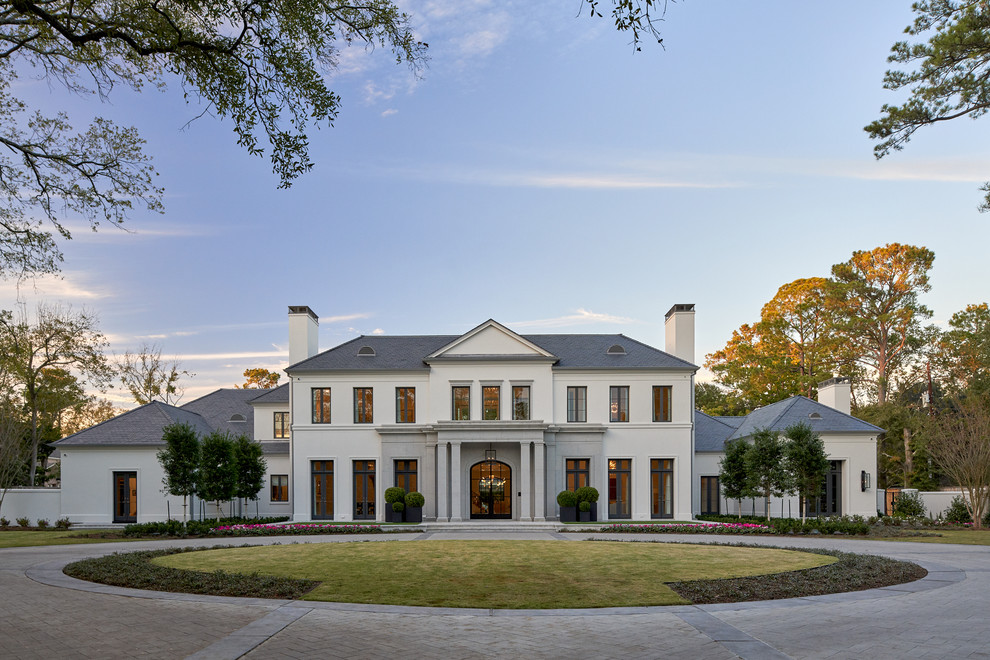 Inspiration for a transitional two-storey white house exterior in Houston with a gable roof.