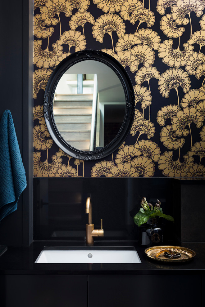 This is an example of a small contemporary powder room in Melbourne with an undermount sink, flat-panel cabinets, black cabinets, engineered quartz benchtops, ceramic tile, black walls and black tile.
