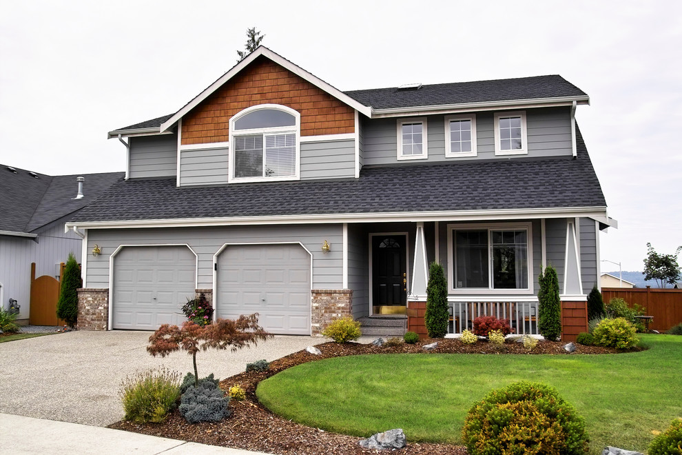 Design ideas for a large traditional two-storey grey exterior in Minneapolis with mixed siding.