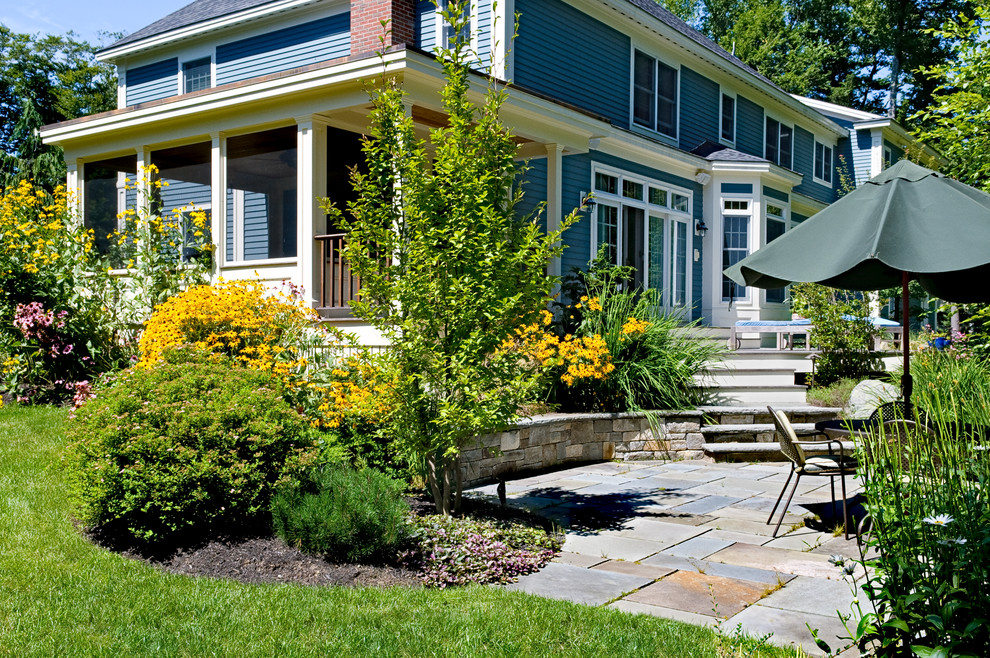 Mid-sized traditional backyard patio in Portland Maine with natural stone pavers.