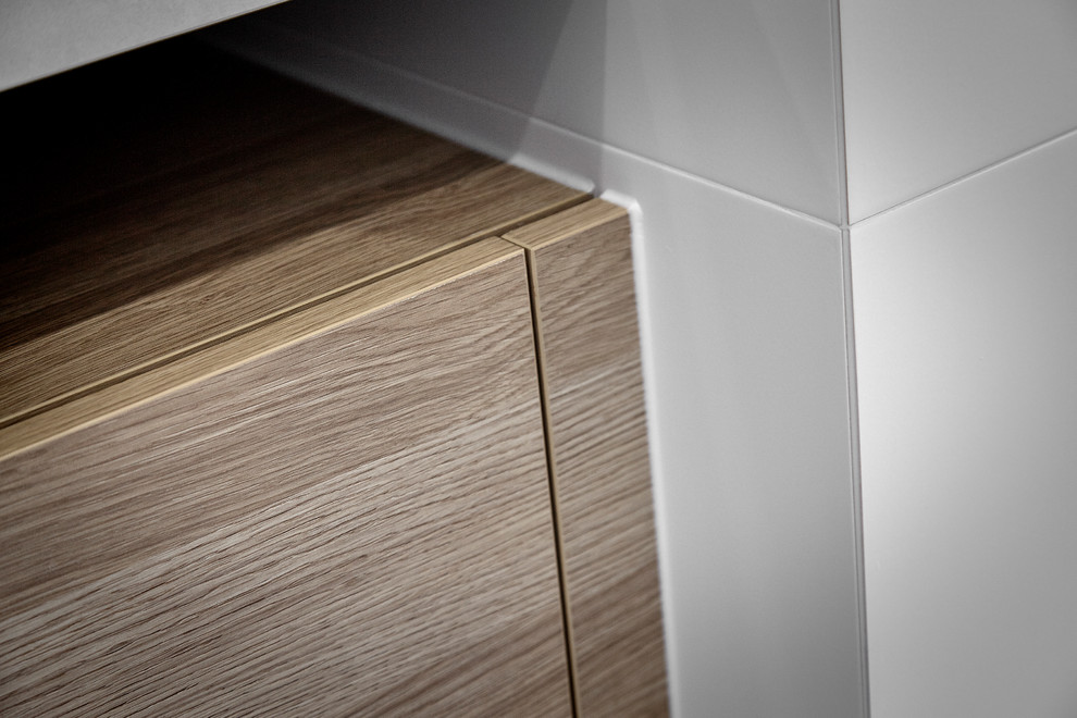 This is an example of a small contemporary 3/4 bathroom in Other with light wood cabinets, an open shower, a two-piece toilet, gray tile, white walls, ceramic floors, a vessel sink, engineered quartz benchtops, limestone, grey floor, an open shower and white benchtops.