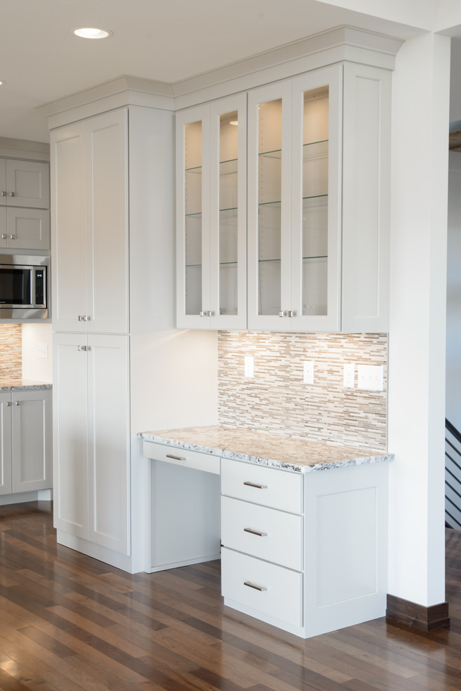 Transitional l-shaped medium tone wood floor open concept kitchen photo with a farmhouse sink, shaker cabinets, white cabinets, stainless steel appliances and an island