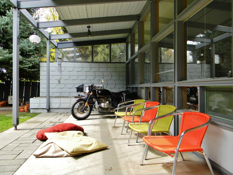 Midcentury patio in Seattle with a roof extension.