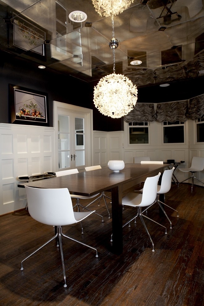 Inspiration for a contemporary separate dining room in Seattle with black walls, dark hardwood floors and no fireplace.