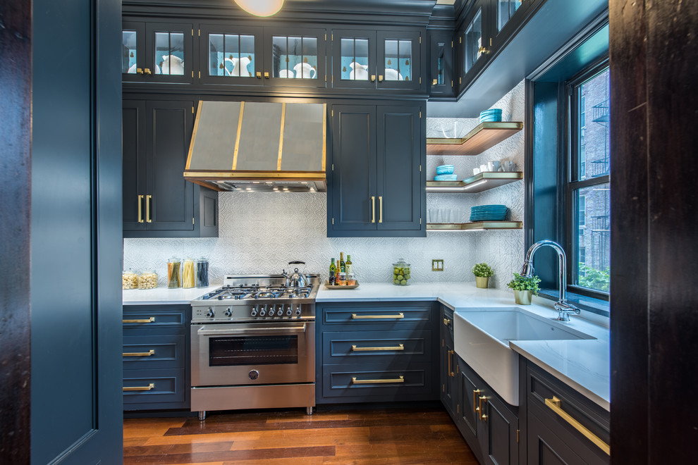 Inspiration for a transitional l-shaped medium tone wood floor and brown floor enclosed kitchen remodel in New York with a farmhouse sink, shaker cabinets, blue cabinets, gray backsplash, stainless steel appliances and no island