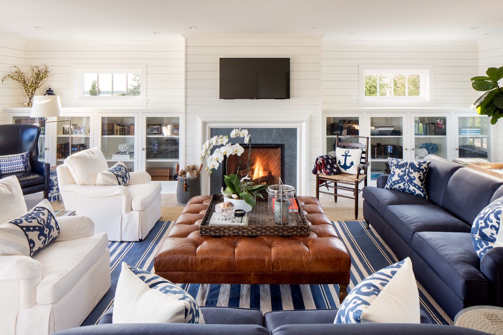 Example of a large beach style open concept light wood floor family room design in New York with white walls, a standard fireplace, a wall-mounted tv and a tile fireplace