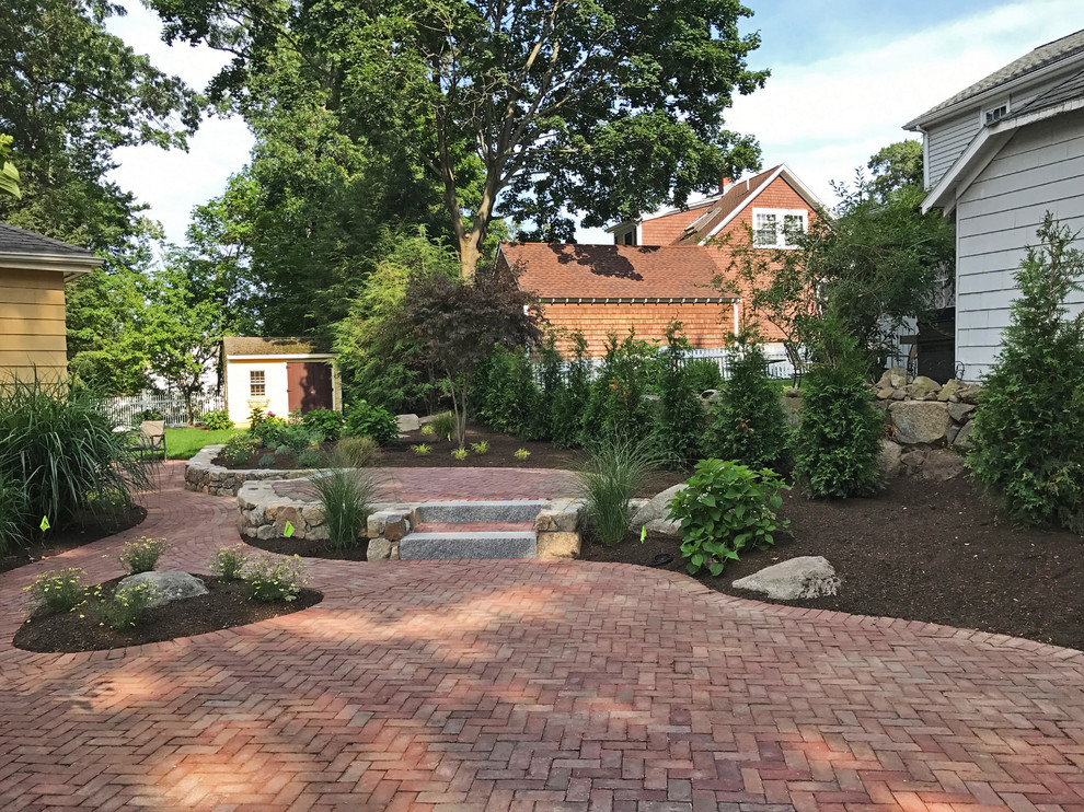 Photo of a mid-sized traditional backyard full sun formal garden for summer in Boston with a garden path and brick pavers.