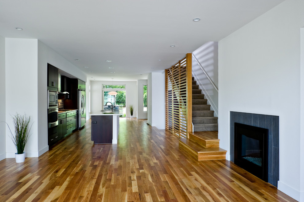 Photo of a modern open concept living room in Denver with light hardwood floors.