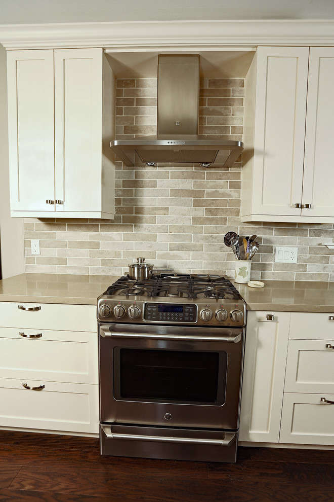 Open concept kitchen - mid-sized transitional galley dark wood floor and brown floor open concept kitchen idea with an undermount sink, shaker cabinets, beige cabinets, quartz countertops, beige backsplash, porcelain backsplash, stainless steel appliances and no island